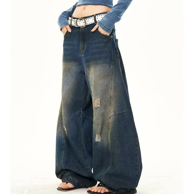 Trendy washed wide-leg jeans with ripped details and an inverted dirty finish, offering a bold and edgy street-style look. Perfect for casual and fashion-forward outfits.