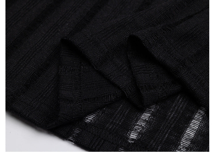 Close-up of black fabric with visible stitching on a white background