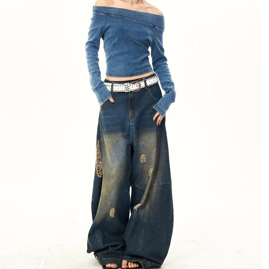 Trendy washed wide-leg jeans with ripped details and an inverted dirty finish, offering a bold and edgy street-style look. Perfect for casual and fashion-forward outfits.