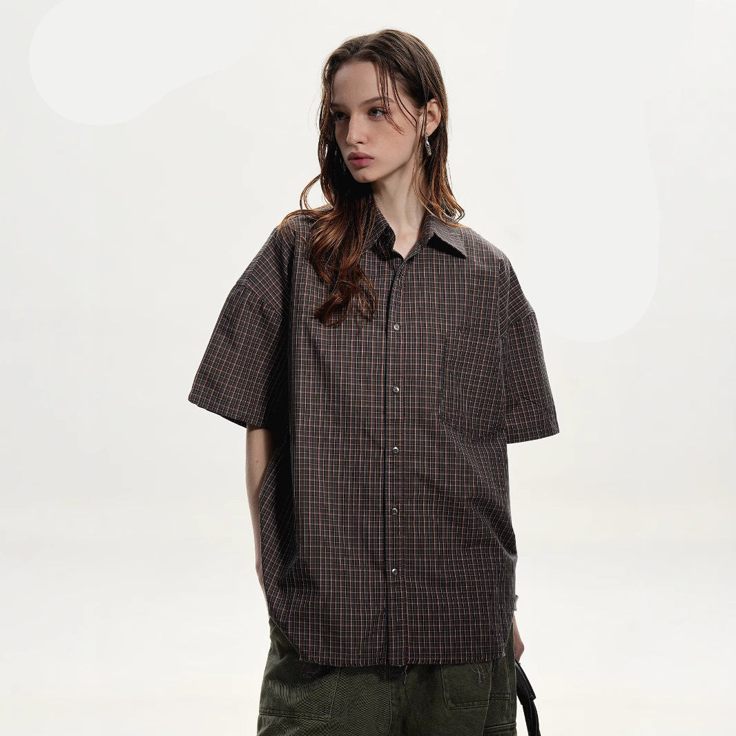 Woman wearing a plaid shirt with brand logo and product features on a white background