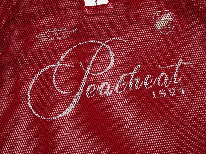 Red textured fabric with 'Peachleaf' branding and text