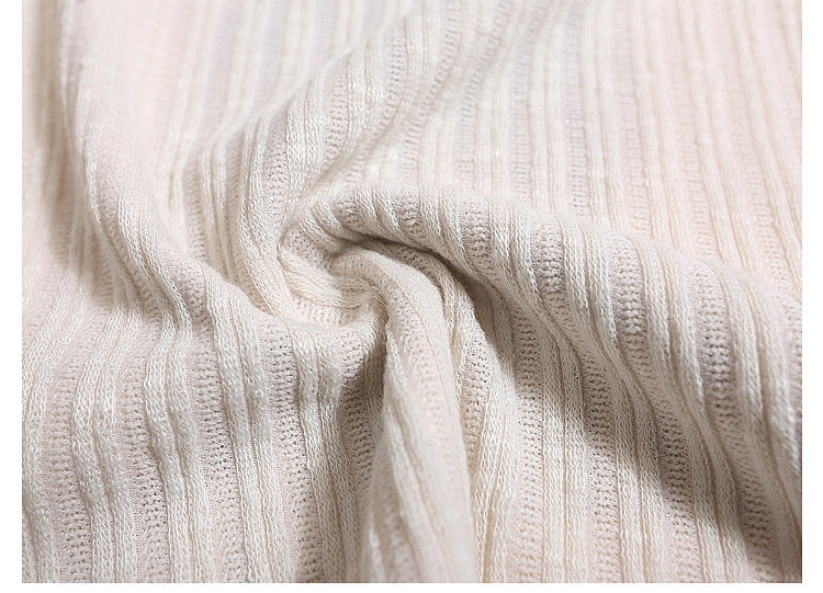 Close-up of textured white fabric with visible pattern