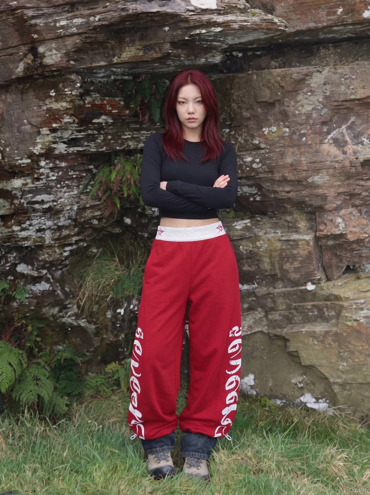 DAXUEN red wide-leg pants with distressed script graphic — model photo