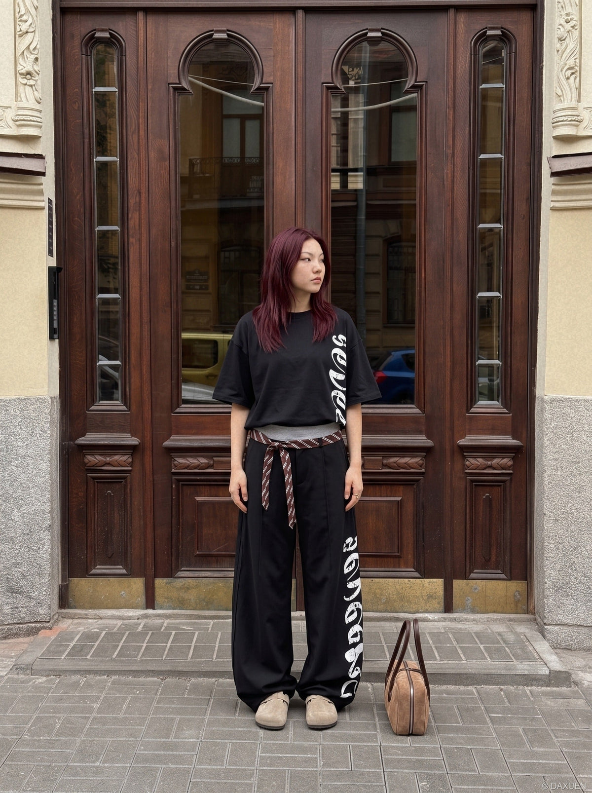 DAXUEN red wide-leg pants with distressed script graphic — model photo