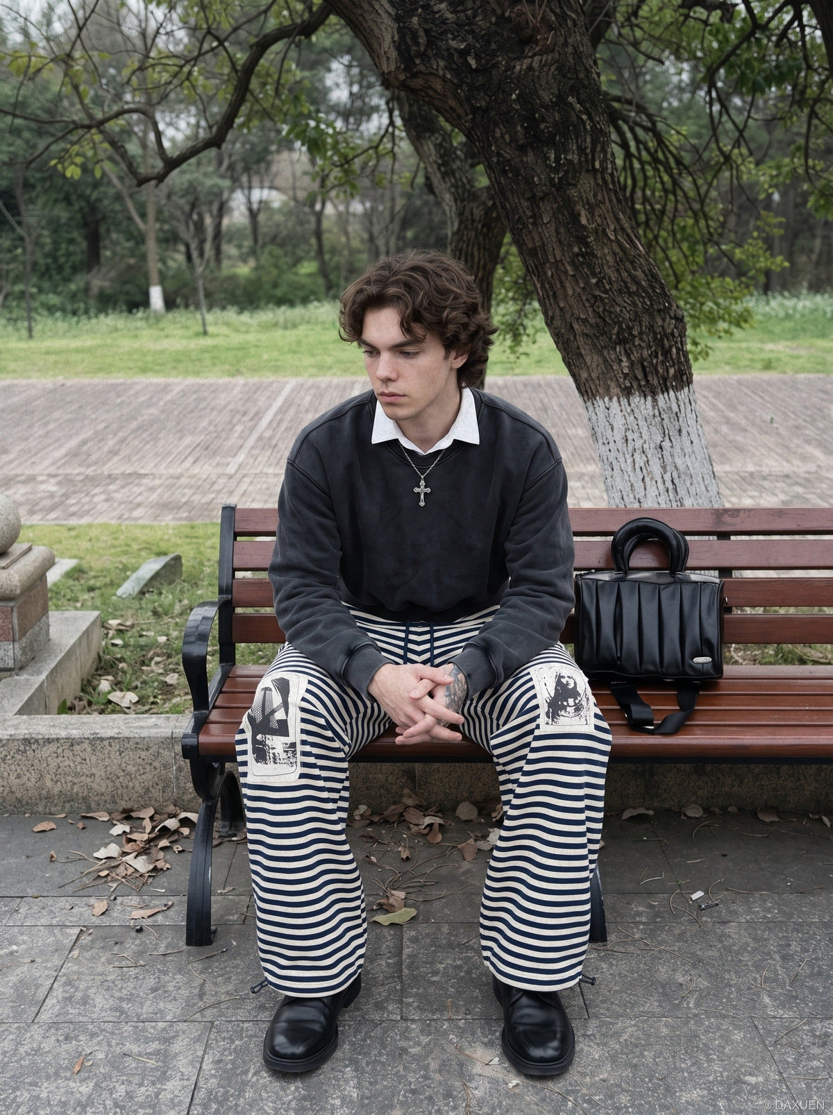 DAXUEN striped wide-leg pants with skull and structure patches — model photo