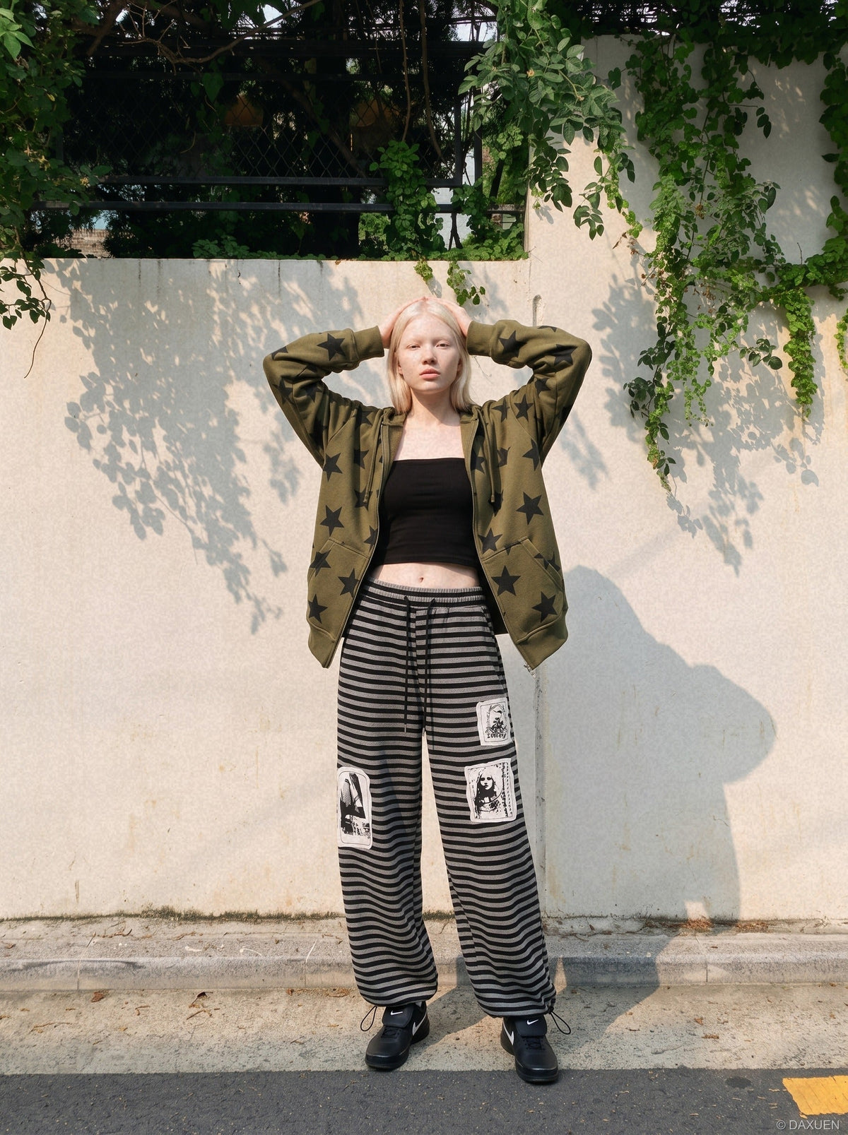 DAXUEN striped wide-leg pants with skull and structure patches — model photo