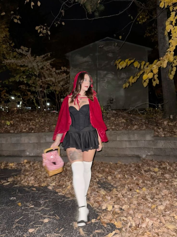 Little Red Riding Hood Halloween outfit with red hooded cape, black corset, black skirt and woven picnic basket